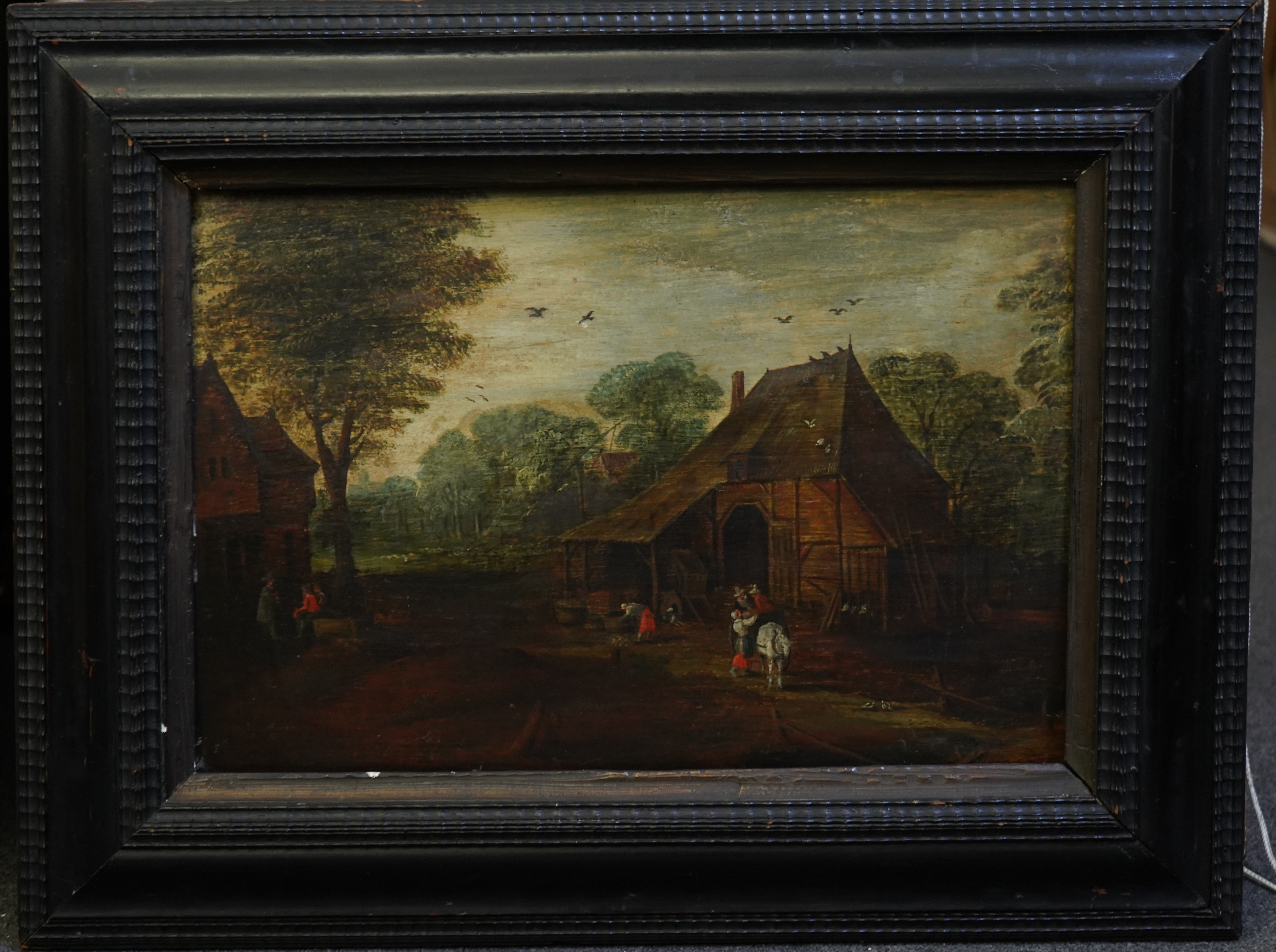 Follower of Jan Breughel the Elder (1568-1625), Village scene with figures beside a house, oil on panel, 34 x 51cm